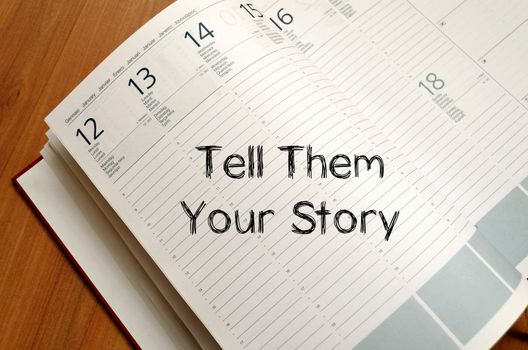 Tell them your story text concept write on notebook