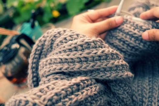 Knit man scarf for cold day in winter, hobby leisure with handmade gift for father day, woman hand knitting from yarn, nice present in vintage color