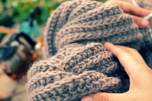 Knit man scarf for cold day in winter, hobby leisure with handmade gift for father day, woman hand knitting from yarn, nice present in vintage color