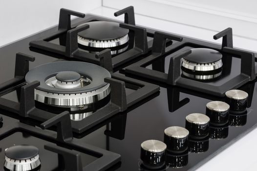Gas stove with stainless tray selling in appliance retail store, closeup