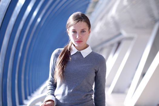 Young Businesswoman standing in corridor of modern office building