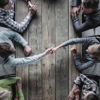 Hipster business people shaking hands, teamwork brainstorming planning meeting concept