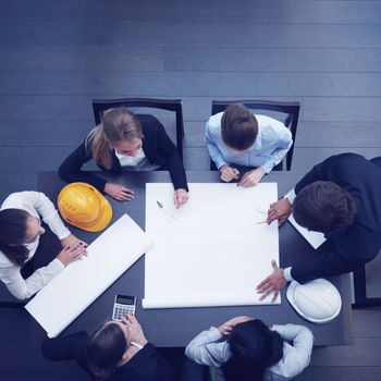 Top view of people around table in construction business meeting