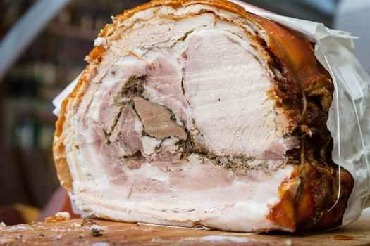 The porchetta is a typical central Italian dish. It consists of a whole pig, emptied, boned and cooked