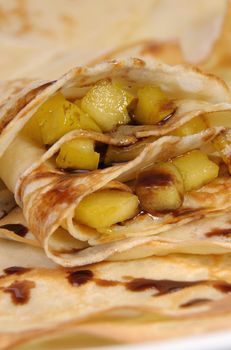 Pancakes sliced apples with caramel and chocolate for breakfast