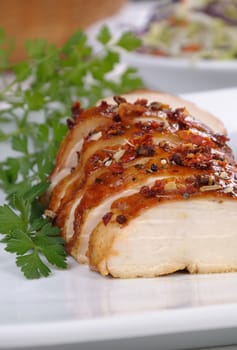 Baked chicken breast with spice sliced on a plate