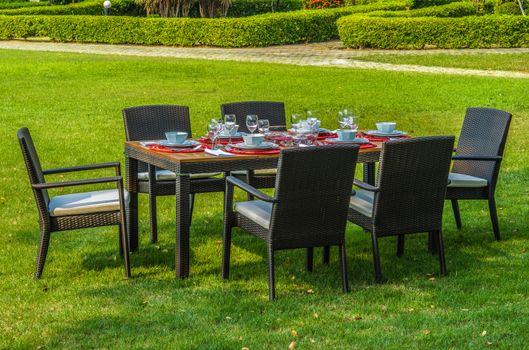 Water resistant outdoor rattan furniture, table, chairs and outdoor cushions