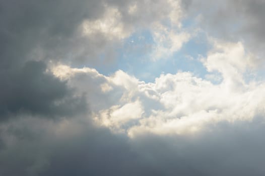 Bright sun reflected on clouds in sky with copy space for moody transfiguration concept background