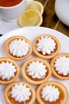 plate of shortbread cookies with orange jam and cream