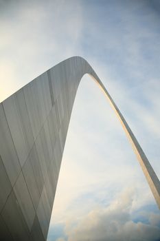 St. Louis Gateway Arch, famous steel structure rises into a bright cloudy sky.