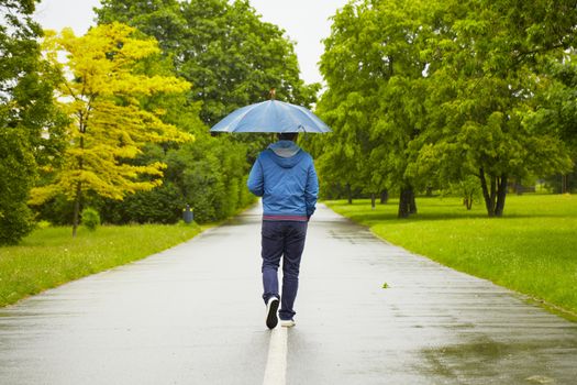 Rainy day - young man with umbrella 