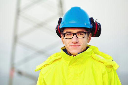 Worker wearing reflective clothing with helmet.