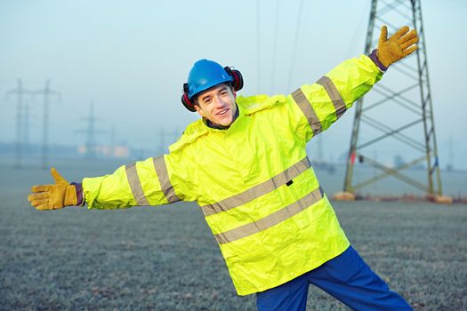 Worker wearing reflective clothing with helmet.