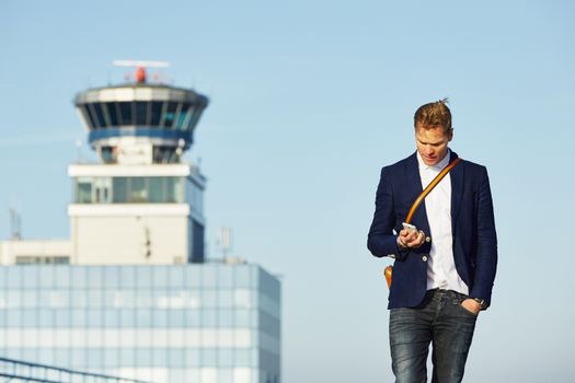 Handsome businessman is waiting at the airport 