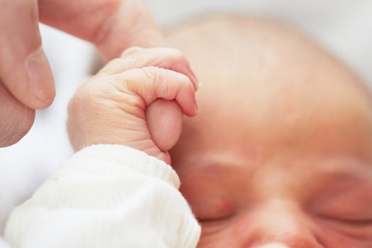 Newborn baby with father - selective focus