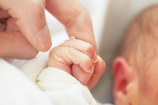 Newborn baby with father - selective focus