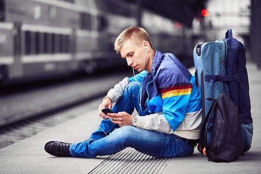 Young traveler is waiting at the railway station