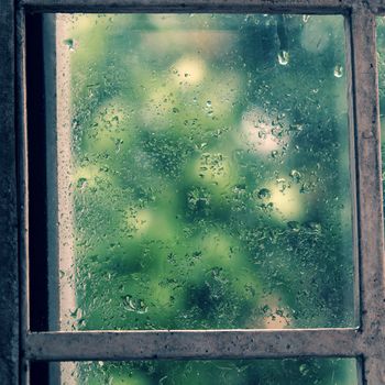 Rain drop on window in rainy day, glass with green background as seperation, nice background for love