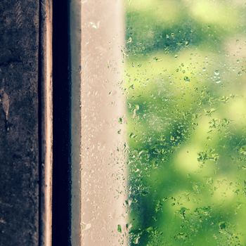 Rain drop on window in rainy day, glass with green background as seperation, nice background for love