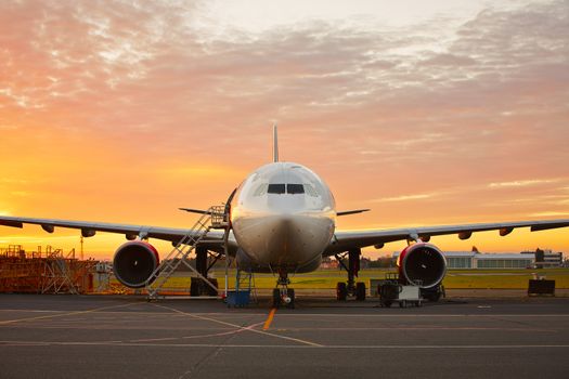 Aircraft maintenance  - large aircraft at the beautiful sunrise