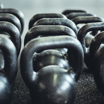 Kettlebells organized and put away at the gym.