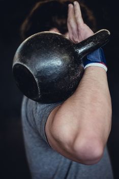 Man working out with a kettlebell.