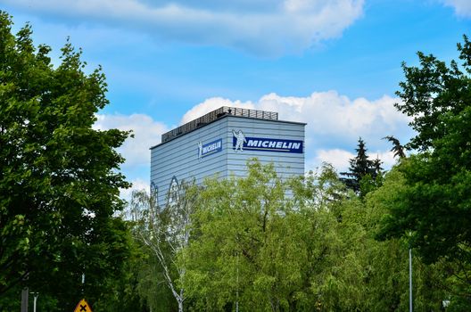 Michelin logo sign on blue sky background. Bibendum, commonly referred to as the Michelin Man, is the symbol of the Michelin tyre company.Michelin manufactures tyres for space shuttles, aircraft, automobiles, heavy equipment, motorcycles, and bicycles. Editorial photo.  
Photo taken on: 14 June 2016 in Olsztyn-Poland
