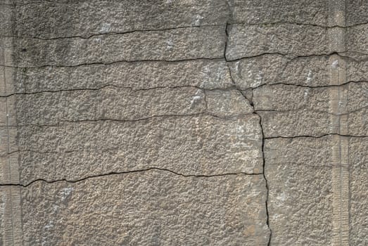 fragment of a concrete wall, which has undergone deformation due to prolonged exposure to various climatic conditions