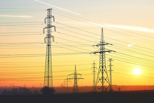 Silhouette electricity pylons during sunset - Czech Republic