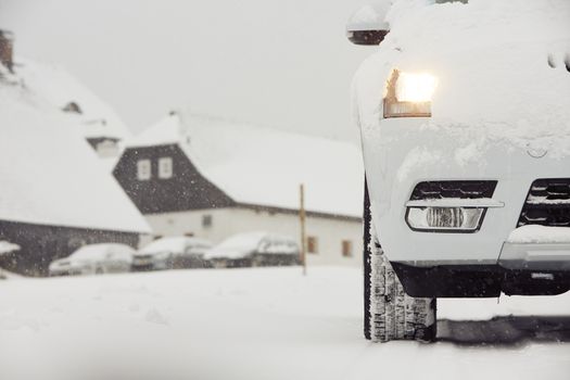 Head light of the car on winter road