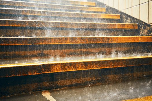 Heavy rain in the city. Rain droplets on the staircase during downpour.