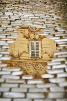 After rain in Prague - reflection of the house in puddle