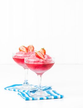 Frozen strawberry drink garnished with fresh berries.