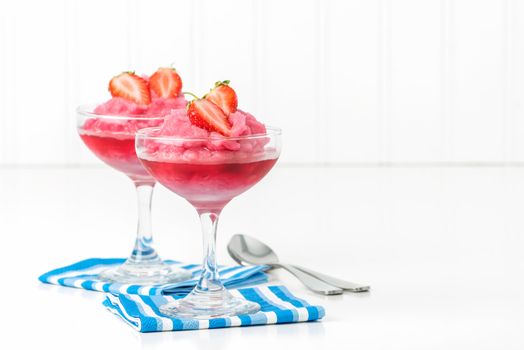Two small dishes of homemade strawberry sorbet with fresh berries.