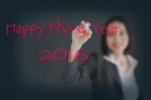 Beautiful businesswoman writing Happy New Year