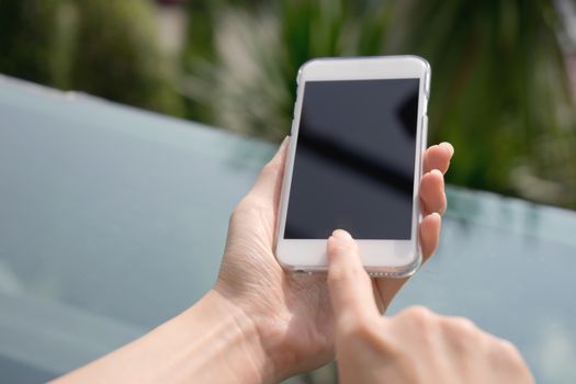 Closeup image of a female hands using smartphone