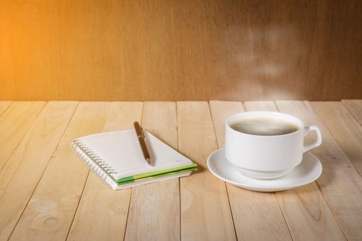 warm cup of coffee on wood background.