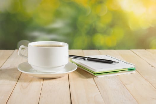 warm cup of coffee on nature background.