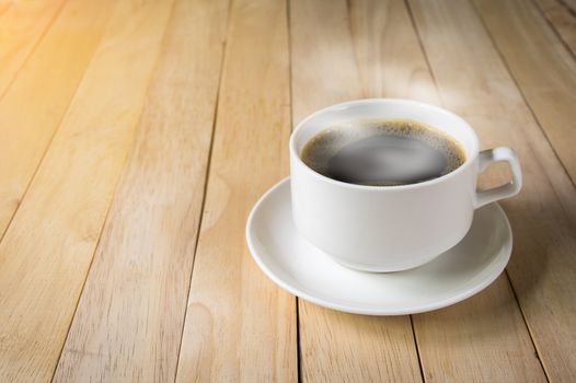 warm cup of coffee on wood background.