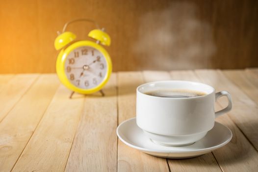 warm cup of coffee on wood background.