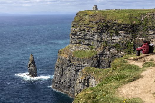 The Cliffs of Moher - located at the southwestern edge of the Burren region in County Clare, Ireland. They rise 120 metres (390 ft) above the Atlantic Ocean at Hag's Head and reach their maximum height of 214 metres (702 ft) here just north of O'Brien's Tower which can be seen on the cliff top.