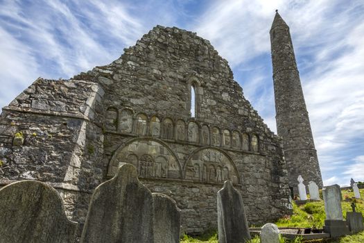 The ruins of Ardmore Cathedral and round tower, County Waterford in the Republic of Ireland. On a hill above the village of Ardmore is a well-preserved 30m, 12th-century round tower and the ruins of a Cathedral dating from the 13th and and an oratory dating from the 8th centuries. The outer walls of the Cathedral features some stone carvings retrieved from an earlier 9th century building. The carvings include a very early image of a harp, images of Adam and Eve in the garden and a representation of Solomon's judgement.