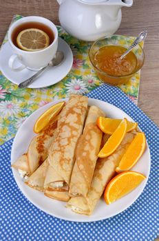 Pancakes stuffed with cottage cheese and oranges for breakfast