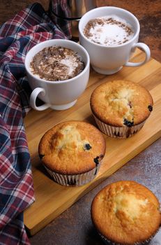 Muffins filling with berries in a cup of coffee cream