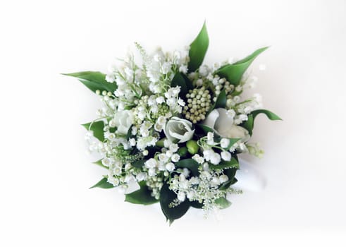Wedding bouquet of lilies of the valley on a white background