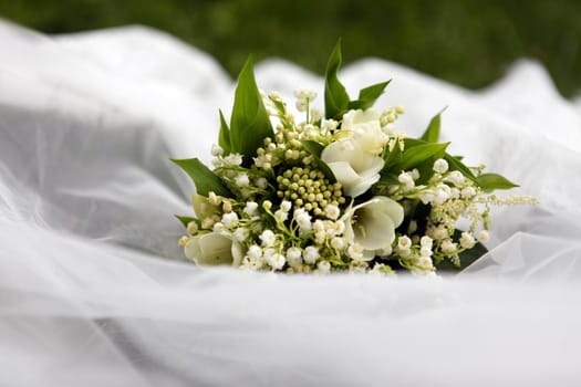 Wedding bouquet of lilies of the valley on a white background
