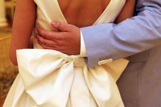 Groom embracing his bride