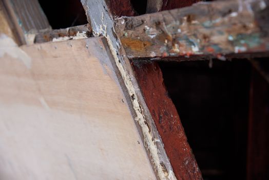 Marine plywood used to repair old ship hull. Very shallow depth of field with the nearest edge of the plywood in focus.