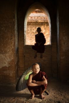 Portrait of young novice monks inside ancient Buddhist temple, Bagan, Myanmar.