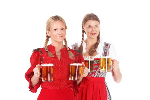 Pretty oktoberfest blonde women holding beer mugs in bar